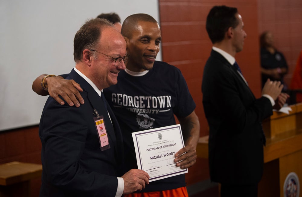 Georgetown President John DeGioia poses for a photo with student Michael Woody at the D.C. Jail. 