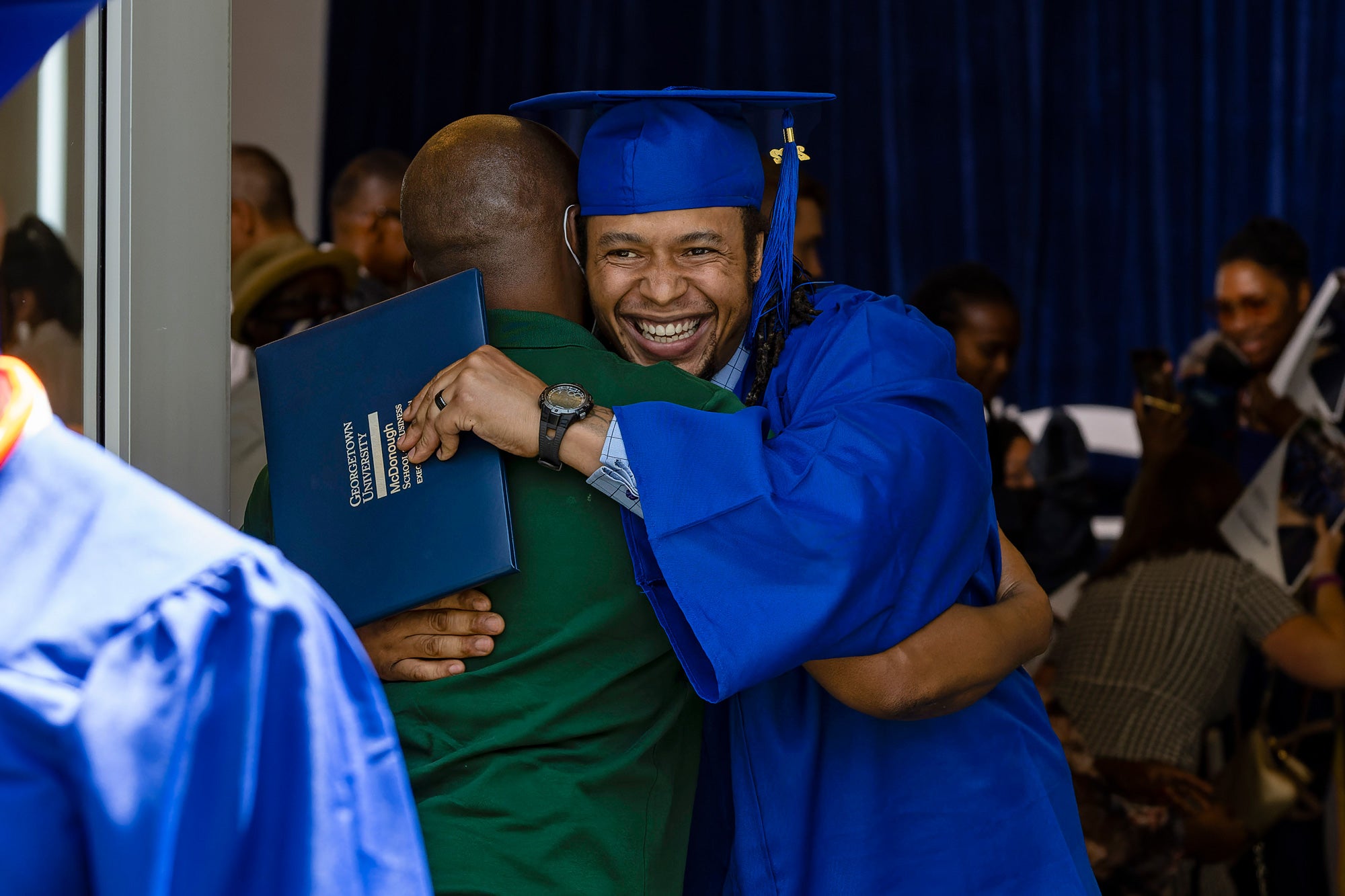 Pivot Program graduate hugs a supporter
