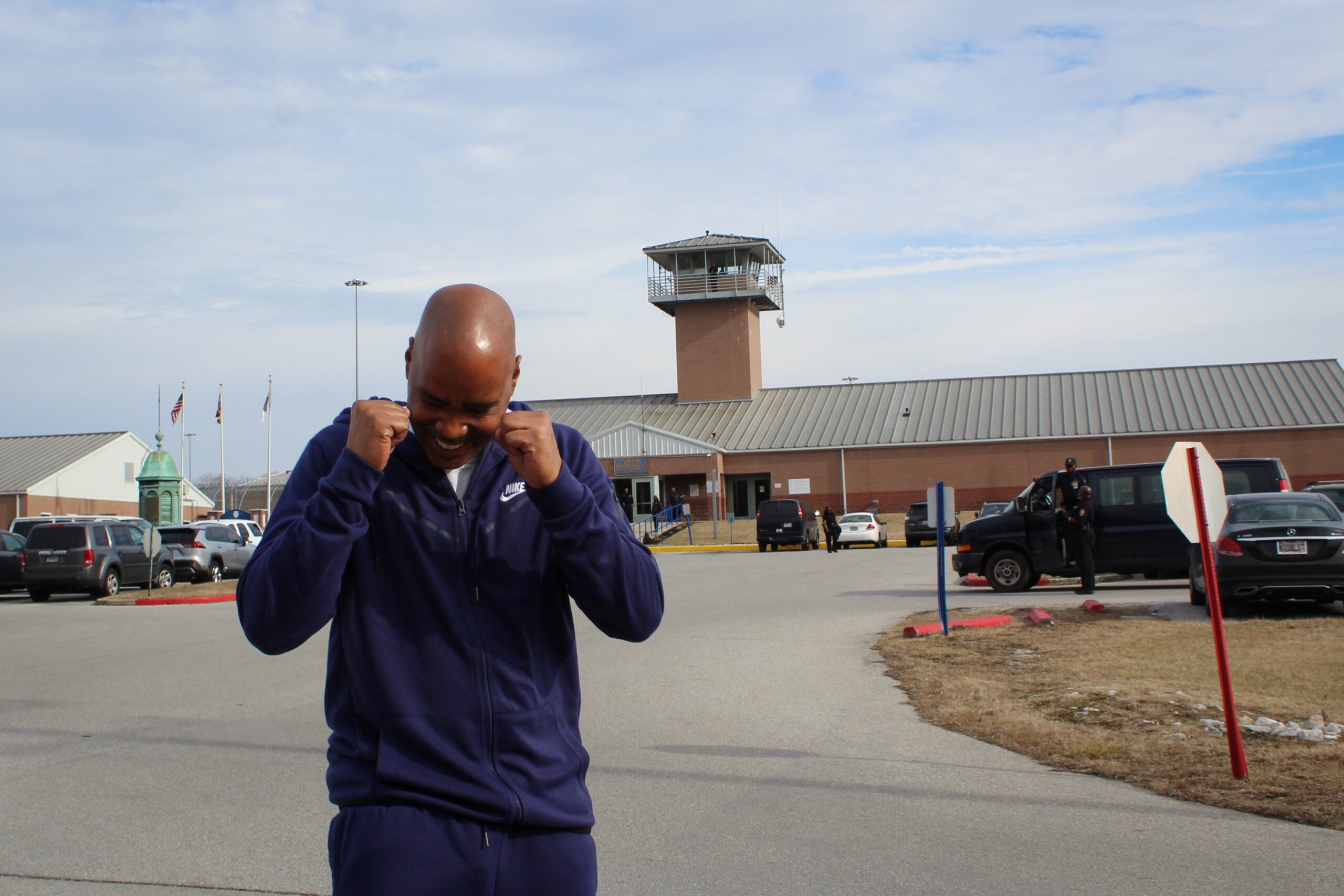 Kenneth Bond celebrates with a prison behind him.