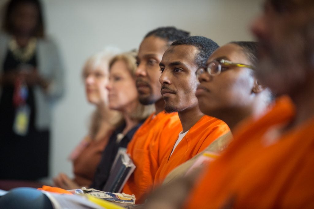 Incarcerated students and visitors at an event.