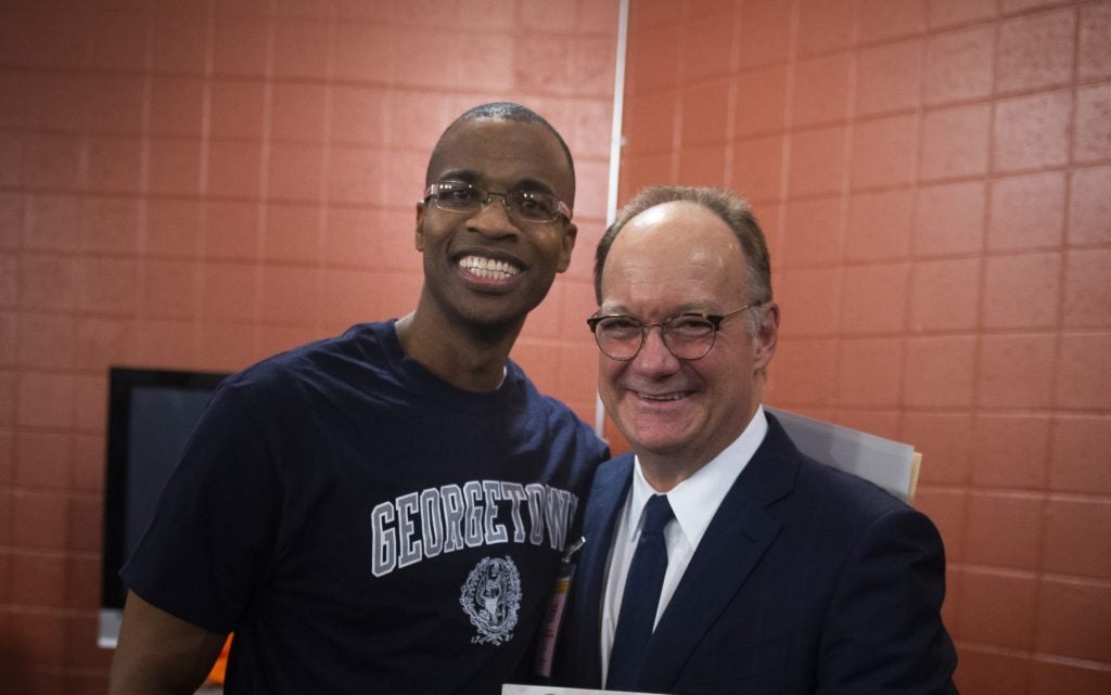 Joel Caston with Georgetown President John DeGioia.