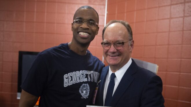 Joel Caston with Georgetown President John DeGioia.