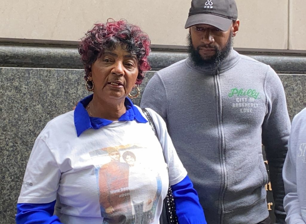 Christine Riddick speaks outside the courthouse.