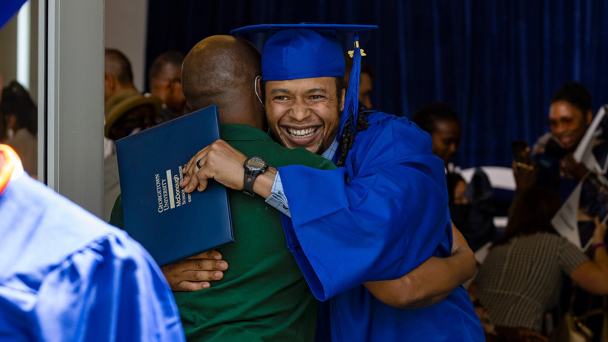Pivot Program graduate hugs a supporter