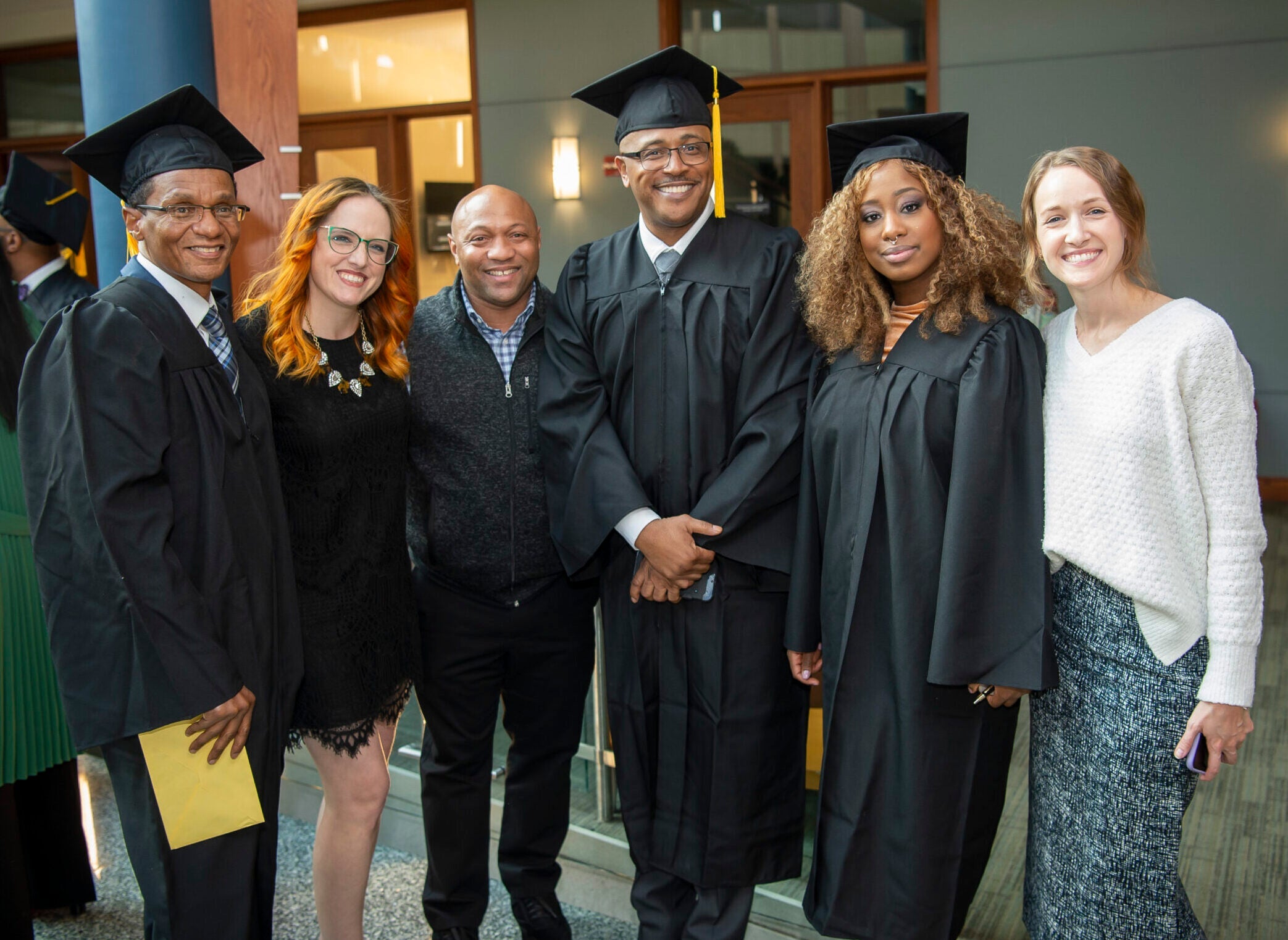 Graduates and staff pose for a photo