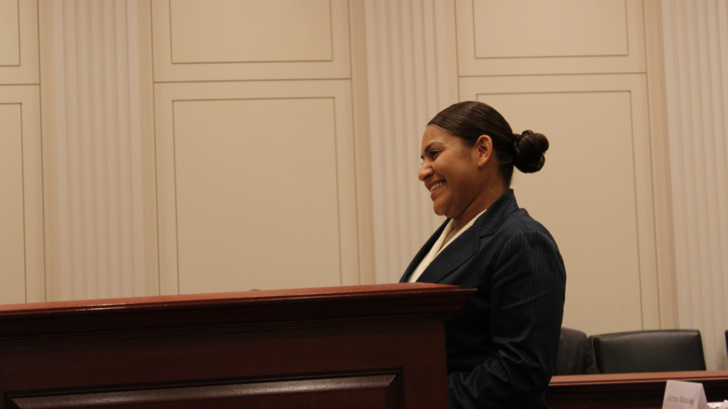 Paralegal Fellow Jessica Trejo at a courtroom podium