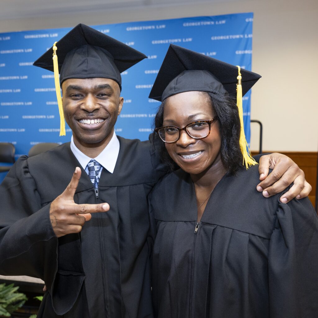 Two Paralegal Program graduates smile at the camera