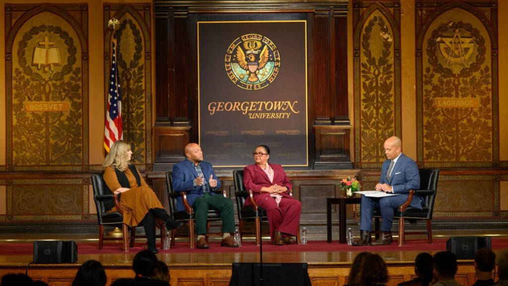 A panel of speakers in Gaston Hall